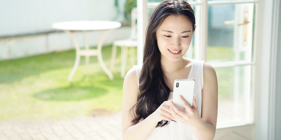 Young asian woman using a smart phone. Mobile communication.
